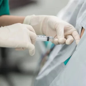 A medical professional performing an intrathecal stem cell injection in Puerto Vallarta