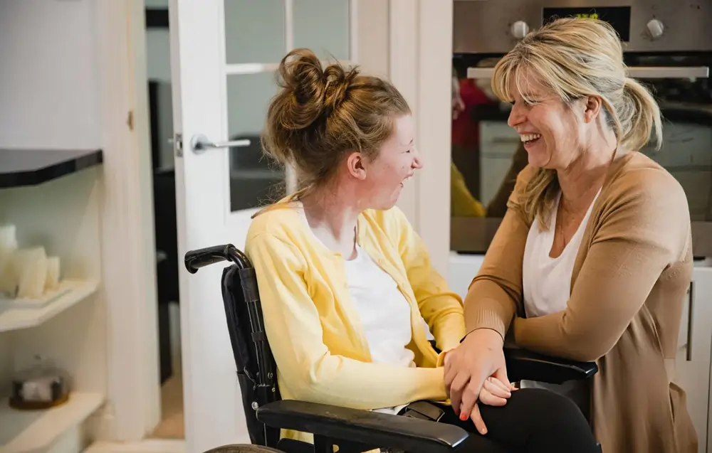 Smiling person in wheelchair in home setting—representing promising ALS outcomes from repeated stem cell treatments