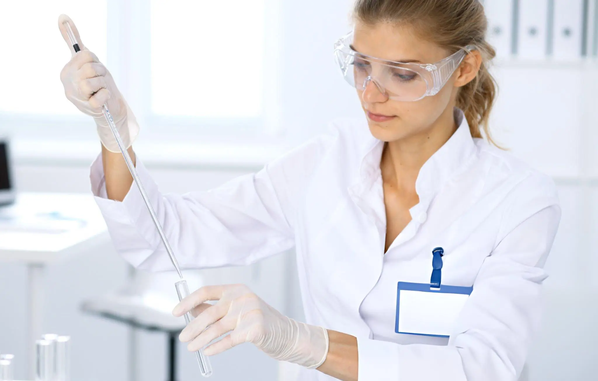 Scientist transferring liquid in lab—representing how mesenchymal stem cells modulate inflammation and promote tissue repair in AS treatment