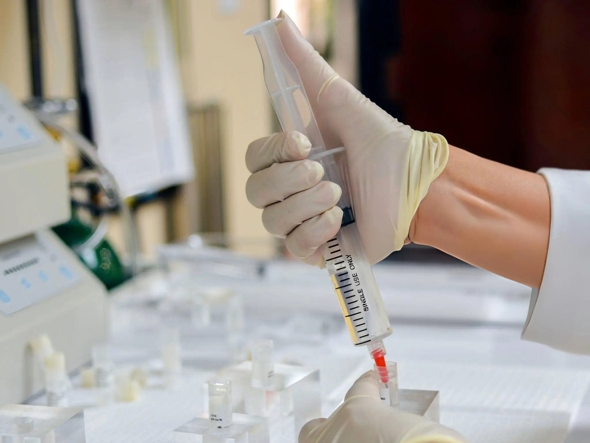 Lab technician preparing syringe—representing safe use of mesenchymal and hematopoietic stem cells from umbilical cord tissue in therapy